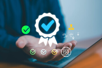 Businessman holding digital quality certification icon with ISO and checkmark symbols, representing standard compliance, quality assurance, and professional business approval in modern technology.