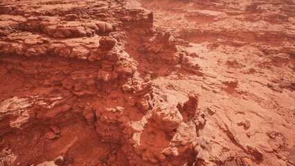 Rugged red rock formations rise above the arid desert, bathed in the warm glow of sunset. The scene captures the beauty of natures artistry, inviting exploration and wonder.