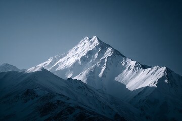Snow-covered mountain peak under clear blue sky