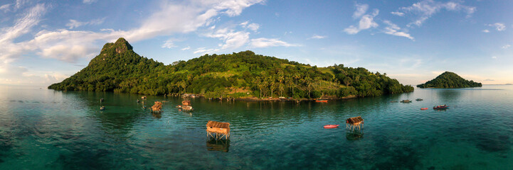 Aerial view of sea gypsy village over clear turquoise waters in Tatagan Island Semporna, Sabah,...
