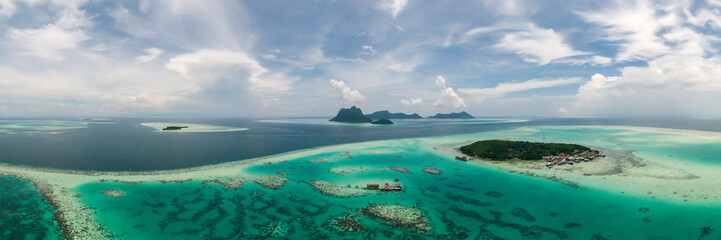 Aerial panoramic view of turquoise waters and tropical islands including Selakan Island, Bohey Dulang, Maiga, and Sibuan in Semporna, Sabah, Malaysia. 