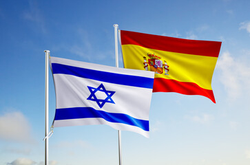 flags of  israel and spain over blue sky background.