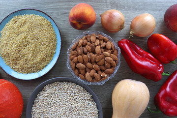 Assortment of various healthy fruits, vegetables, grains and legumes. Top view, wooden background.