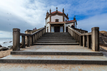 A grand stone staircase leads up to a historic white chapel