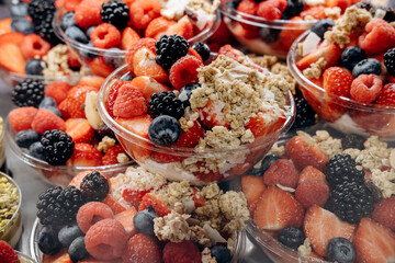 Colorful fruit bowls filled with fresh berries, granola, and yogurt, showcasing vibrant textures and healthy eating options for a nutritious lifestyle