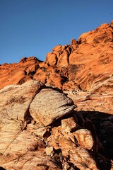 Vibrant Red Sandstone Peaks Rise Majestically Against Azure Skies in Red Rock Canyon's Ancient Desert Embrace, Nevada