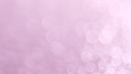 Blurred background with pink bokeh effects, adding a touch of elegance and visual interest