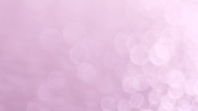 Blurred background with pink bokeh effects, adding a touch of elegance and visual interest
