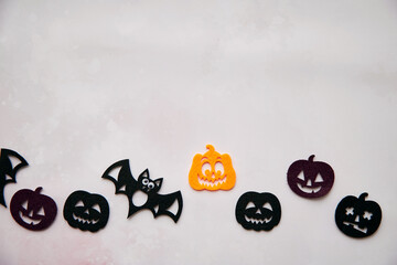Happy Halloween decorations with bats, cute pumpkins. View from above. Minimalistic holiday concept. Copy space for text. Happy Halloween, trick or treat concept. High quality photo
