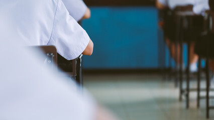Assessment examination of high school students dressed in uniform.The students were doing the exams inside the classroom with stress