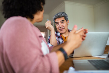 Middle aged couple talking at home