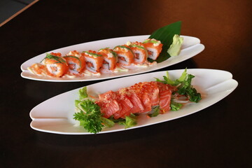 Delectable sushi rolls and sashimi beautifully displayed on plates