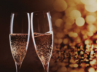 toasting with champagne glasses against holiday lights