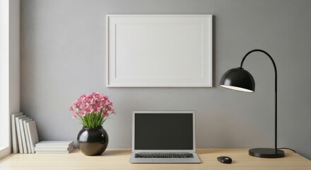 Modern home office setup with laptop desk lamp and framed artwork mockup