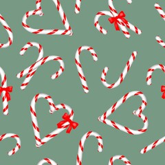 Seamless pattern Christmas candy canes with red and white stripes Festive, curved peppermint sticks on a green mint background