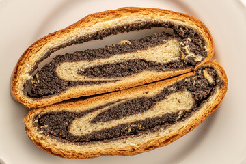 Poppy seed cake, cut into pieces, macro, top view.