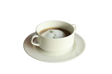 A close-up shot of a cup of creamy soup. The cup sits on a white saucer, offering a simple yet elegant presentation