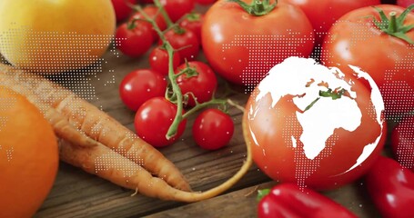 Displaying fresh vegetables on wooden tabletop, with map overlay and globe graphic