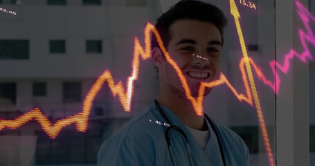 Smiling doctor in scrubs with stethoscope viewing neon graph overlay on glass window clinic hallway