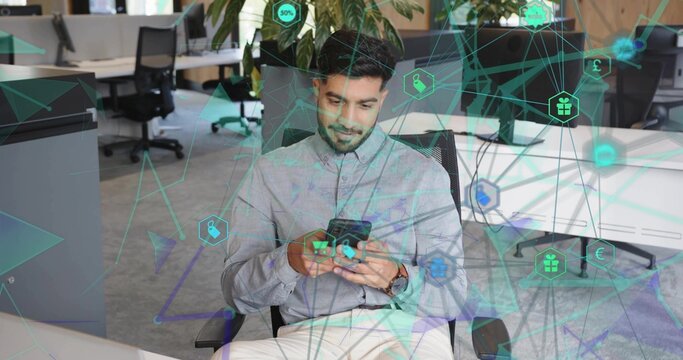 Tapping smartphone screen Indian professional sitting on chair in open-plan office, network overlay