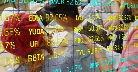 Collaborating professionals analyzing data at wooden table in office, with laptops and data grid