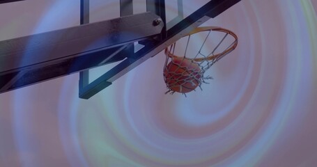 Showing basketball hoop with ball lodged in net on metal support at outdoor court, pastel sky