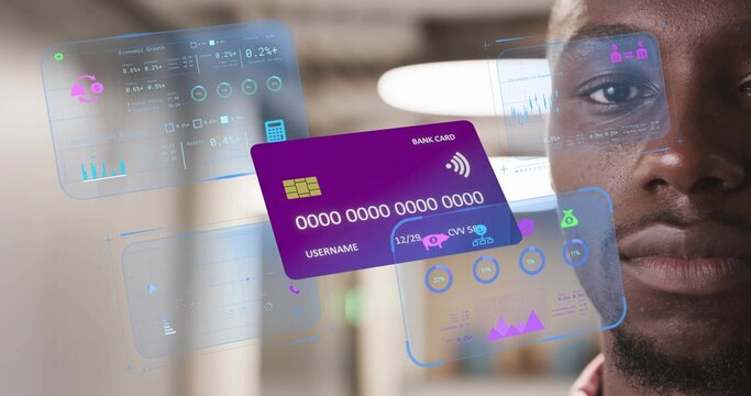 Financial analyst analyzing holographic charts in modern office, with purple virtual bank card
