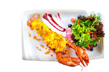 A delicious lobster meal, artistically arranged on a rectangular plate