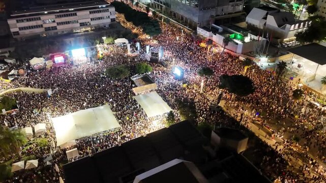 
Aerial Drone View of Mass Protest for Hostage Release in Tel Aviv

Drone footage showing thousands of people gathering in Tel Aviv on October 11, 2025, during a large nighttime protest calling for th
