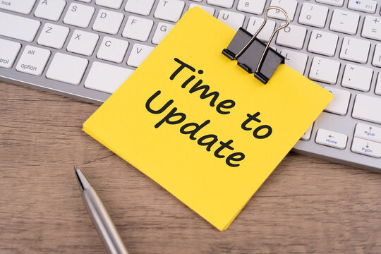 Time to update text on adhesive note - business concept