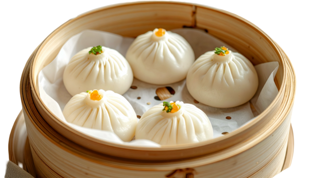 Five plump, steamed buns sit atop paper in a bamboo steamer, garnished with bright orange flecks