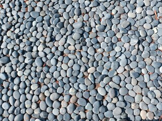 Textured stone floor top view. Natural grey stone neatly laid out on the floor close-up