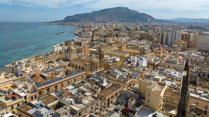 Aerial view of houses and buildings in the historic center of Trapani, Sicily, Italy. It is a beautiful city overlooking the Mediterranean Sea, with a mountain at the horizon.