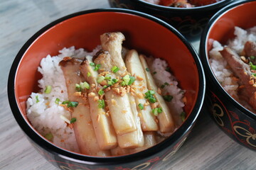 Delicious Asian-inspired food served in a bowl. The rice is topped with cooked mushrooms. 