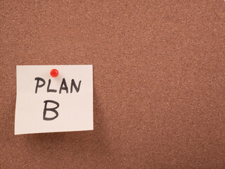 Plan B written on a sticky note pinned to a corkboard