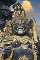 religious stone barong gatekeeper mask sculpture at entrance to Tanah Lot, Bali, Indonesia