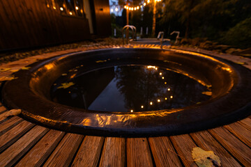 Cozy evening outdoor hot tub and string lights in autumn