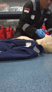 Person, hands or dummy with CPR for first aid training or class at emergency healthcare practice on floor. Closeup, trainer or paramedic with mannequin for life saving lesson or rescue practical