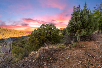 vivid sunset landscape, vivid sunset casting radiant colors over rugged wilderness and mountainous