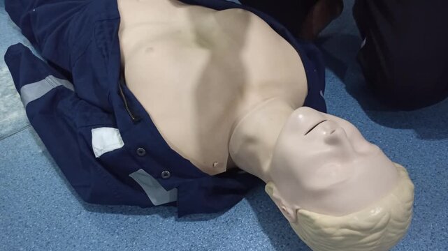 Emergency CPR Training on dummy ,open airway and breathing check on unconscious person, One part of the process resuscitation.