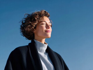 Woman enjoying sunshine feeling calm and happy outdoors
