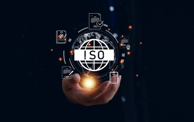 ISO certification and quality management concept. Businessman holding glowing ISO icon with document and checklist graphics, symbolizing standards, compliance, and global quality assurance.