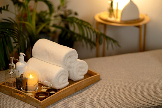 Spa wellness items essential relaxation warm candlelight soft towels oils serene home environment luxurious resort