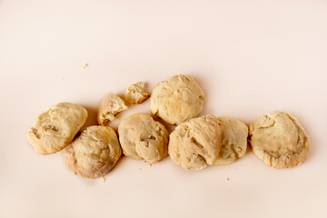 Homemade cookies lying in a pile on a beige background, copy space