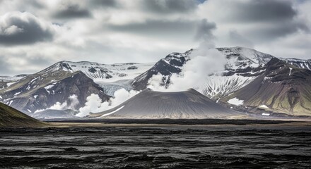 Volcano emitting steam and smoke with snowcapped mountains in the background