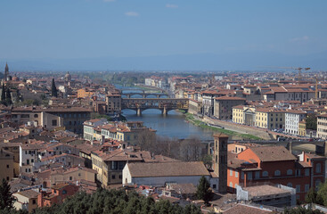 Panoramic view of a historic Italian city with a river and bridges