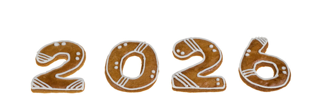 Closeup of happy New year 2026 gingerbread number isolated on a panoramic white background. Set of sweet decorated baked cookies in two, zero and six numerals shape from traditional Czech Xmas pastry.