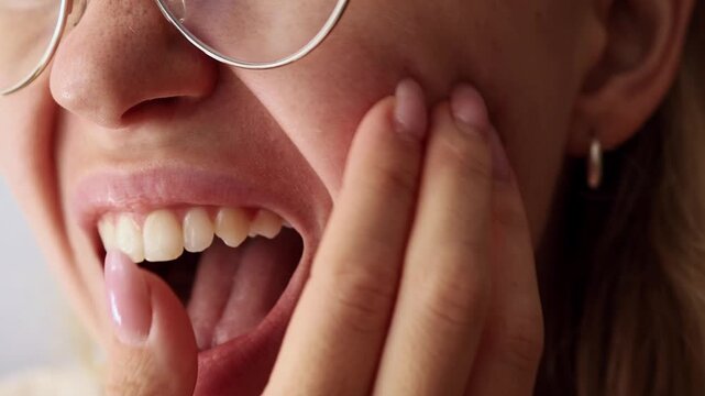 Girl scratching her face with fingers, showing problematic or irritated skin, close-up.