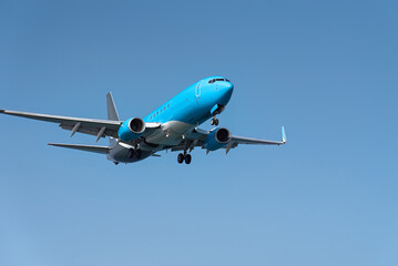 Modern passenger airplane flying in blue sky