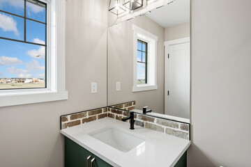 Bathroom with a white sink and a mirror